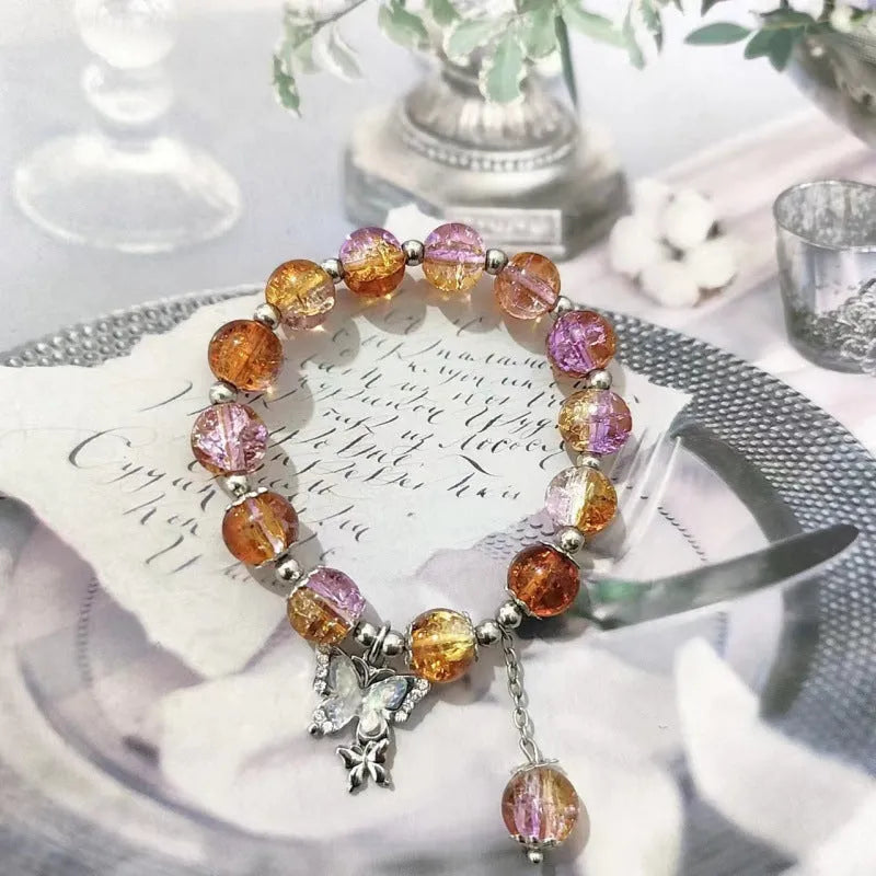 A Chinese style glass bracelet with bamboo leaf and bead designs on a wrist.