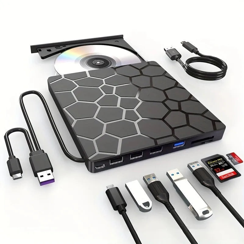Black external USB CD/DVD burner drive on a desk next to a laptop