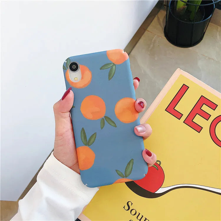 Orange retro plastic back cover phone case for iPhone on a blue and water background.