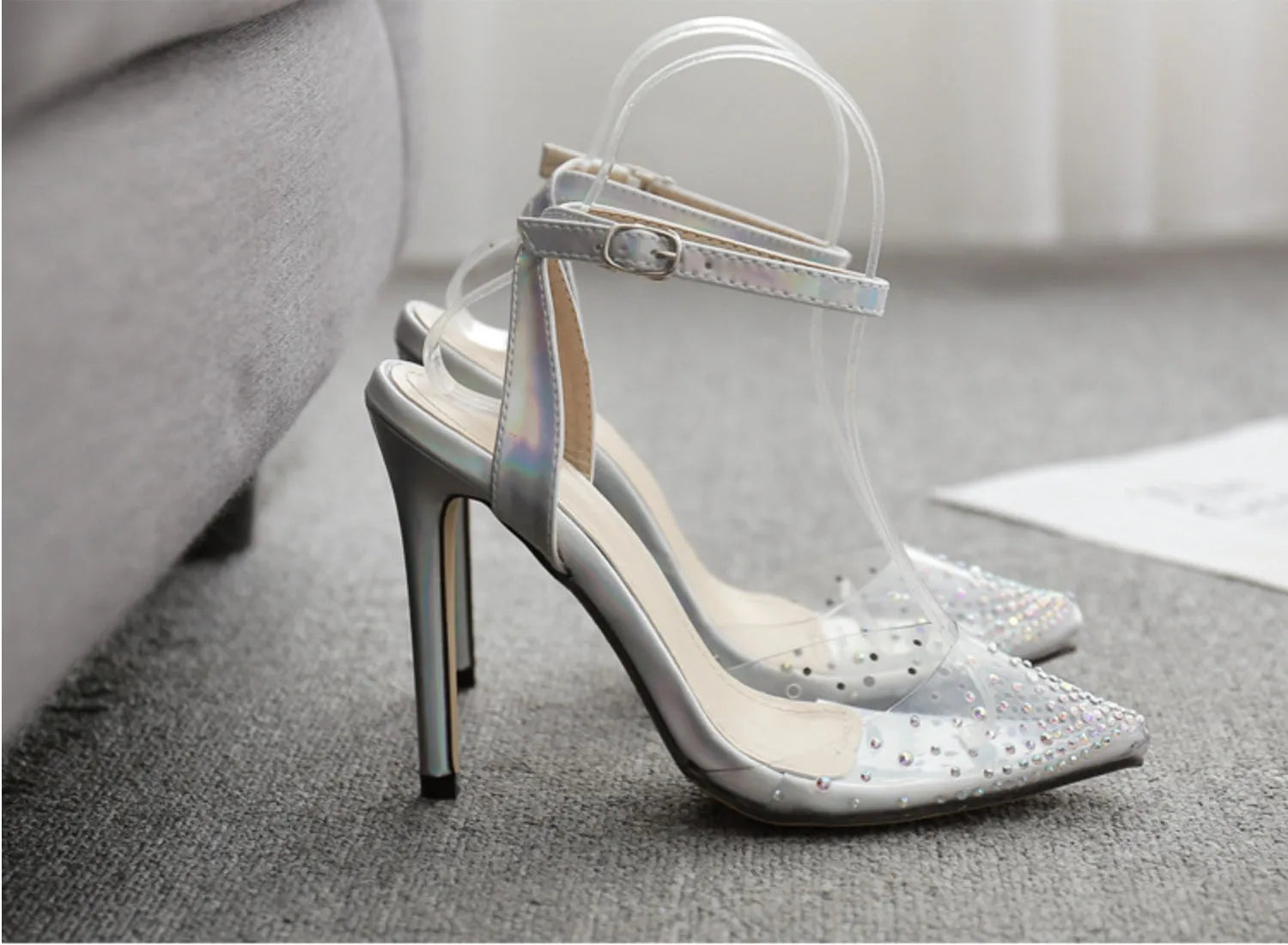 Women's pointed toe stiletto sandals with diamond ornamentation on a PVC upper.