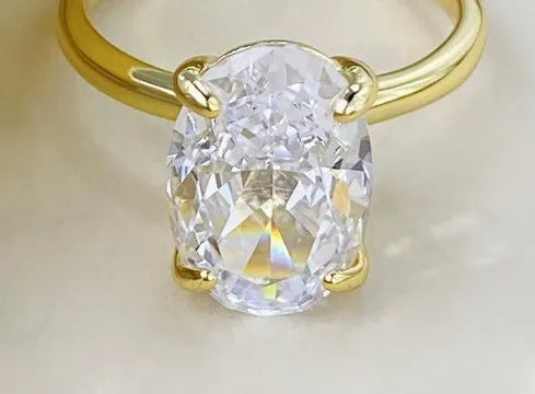 Oval silver ring with four-claw setting displaying hand-cut gemstone centrepiece