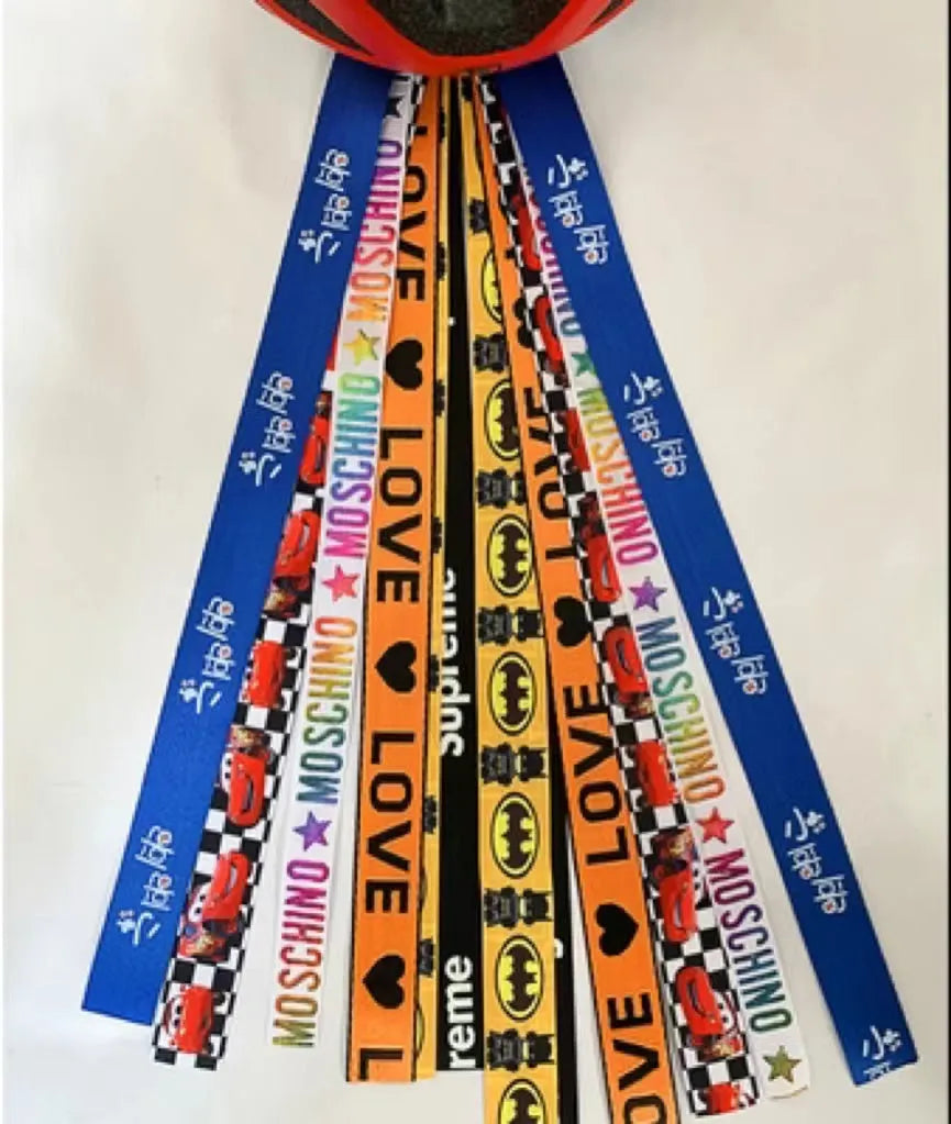 Decorative ribbon streamer for a child's ski or skating helmet in various colour options.