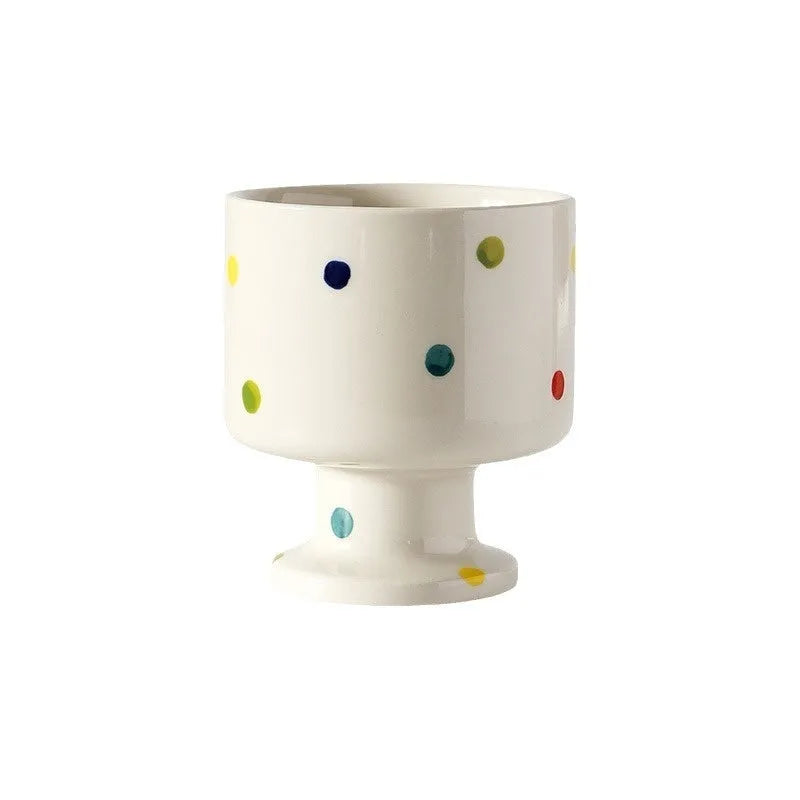 A hand-pinched irregular shaped ceramic mug in a solid colour, shown on a plain background.