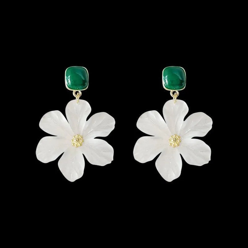 A pair of dark green and alloy needle flowers design drop earrings for women.