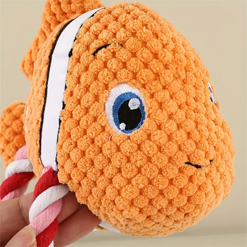 Turtle shaped plush dog toy with knot design and squeaker in grey, green, or orange colours