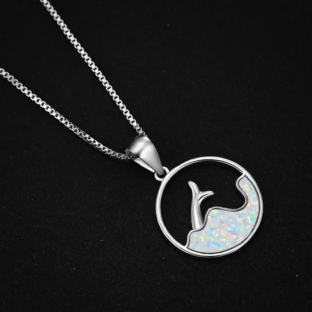 Geometric white gold fishtail necklace with round blue opal centre on model