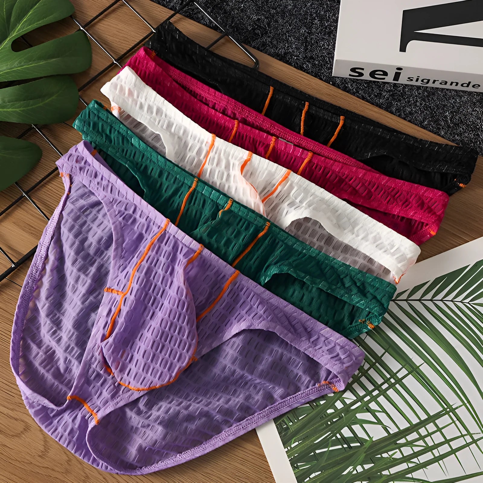 Men's low waist ice silk lace briefs in solid colours on a white background.