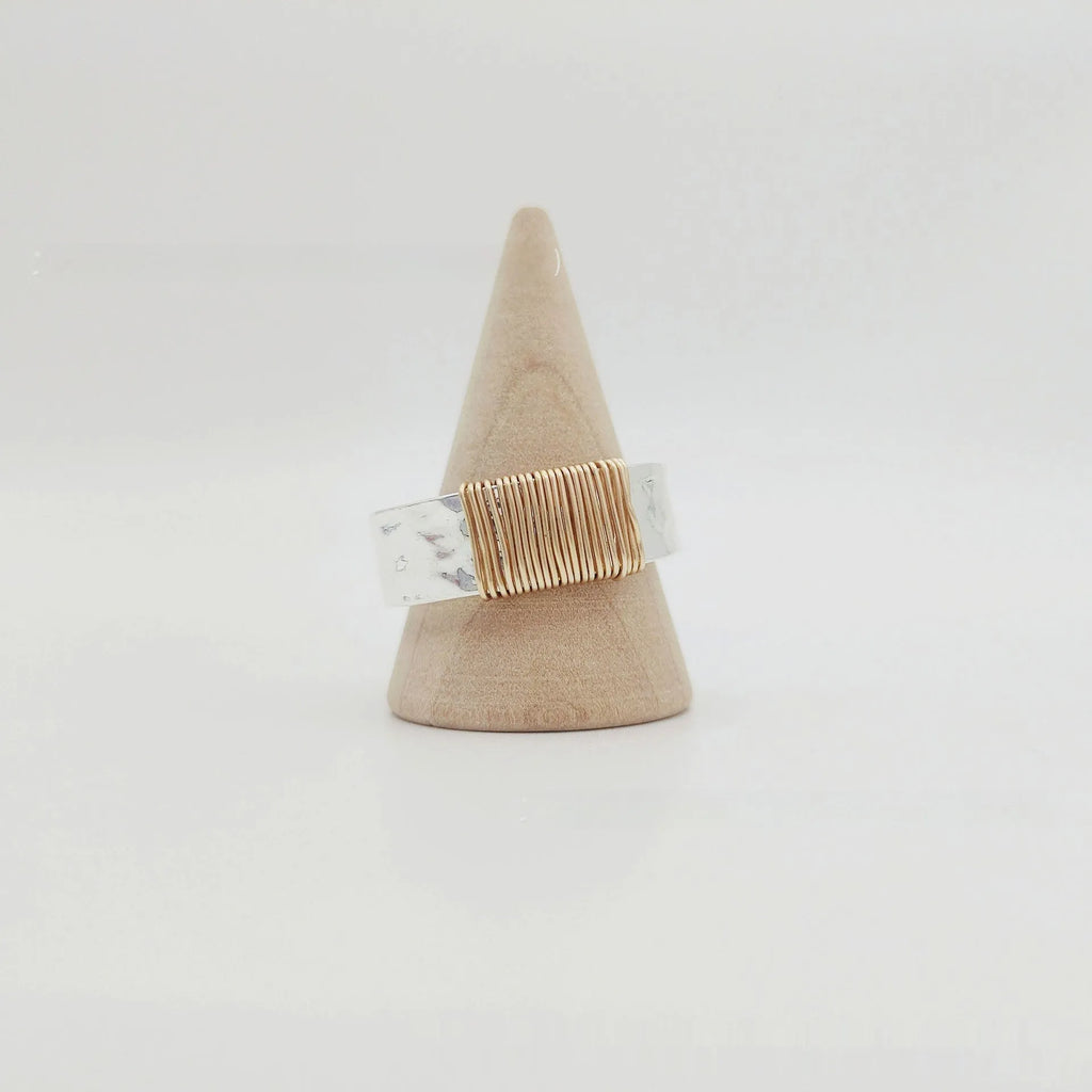Geometric copper bracelet with irregular coil design and silver-gold electroplated finish.