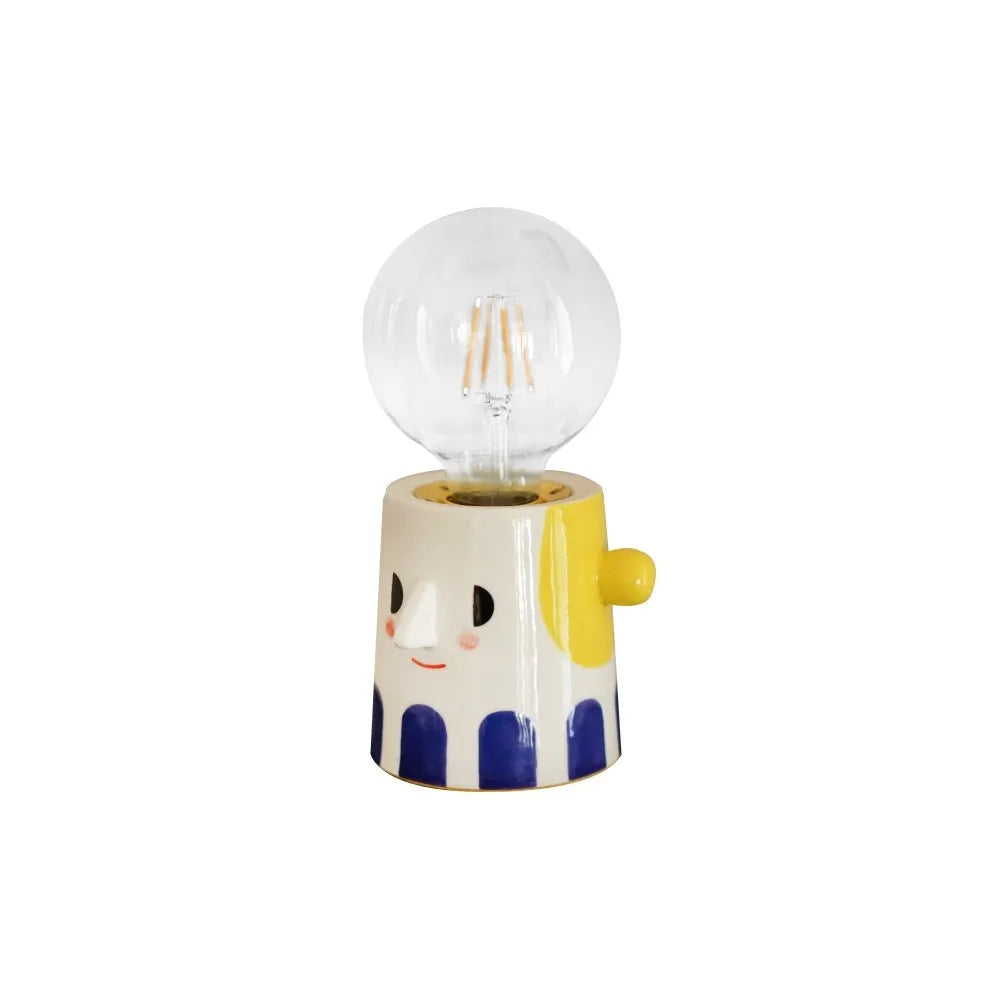 Handmade ceramic bedside lamp with spherical shade on wooden table