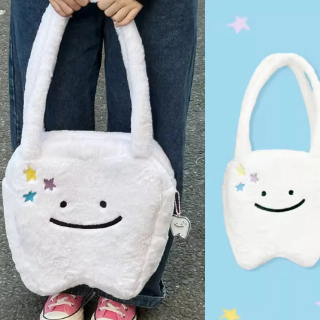 White plush large tooth shoulder tote bag with zip opening shown as crossbody carry