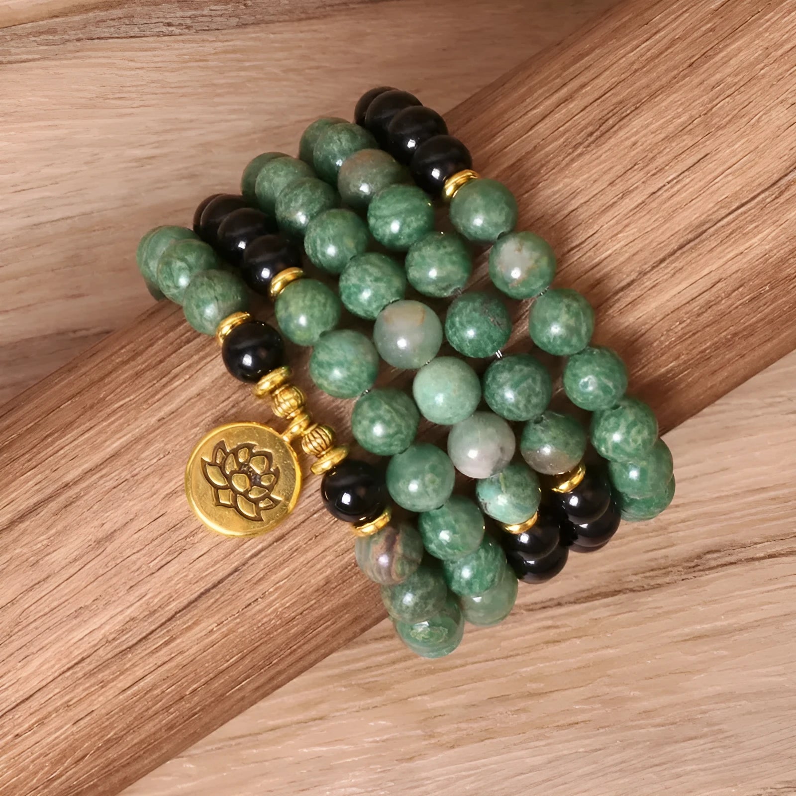 Green and black alloy bead elastic stretch bracelet on a wrist.
