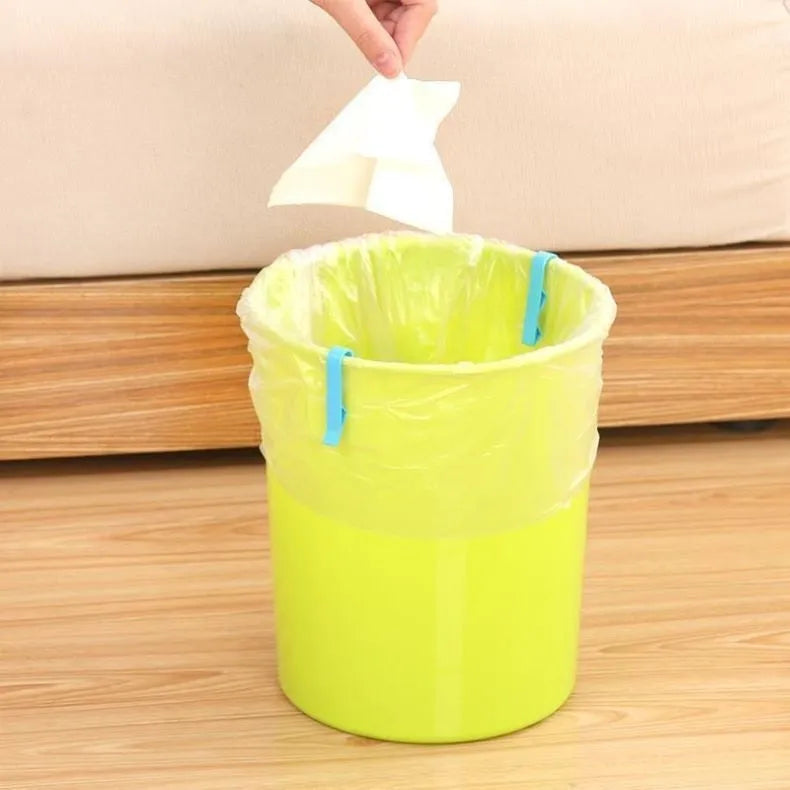 Non-slip plastic fixing clip for holding rubbish bags onto the side of a bin.
