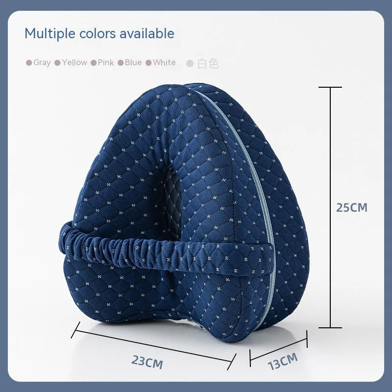 Heart-shaped dark blue memory foam leg pillow for adults on a bed.