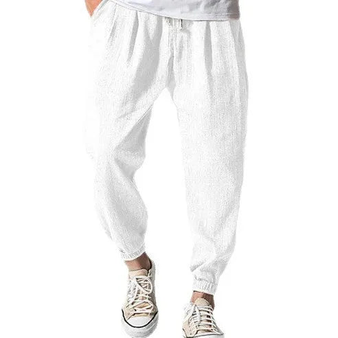 Men's casual cotton trousers with ankle bands in light green colour showing loose fit design