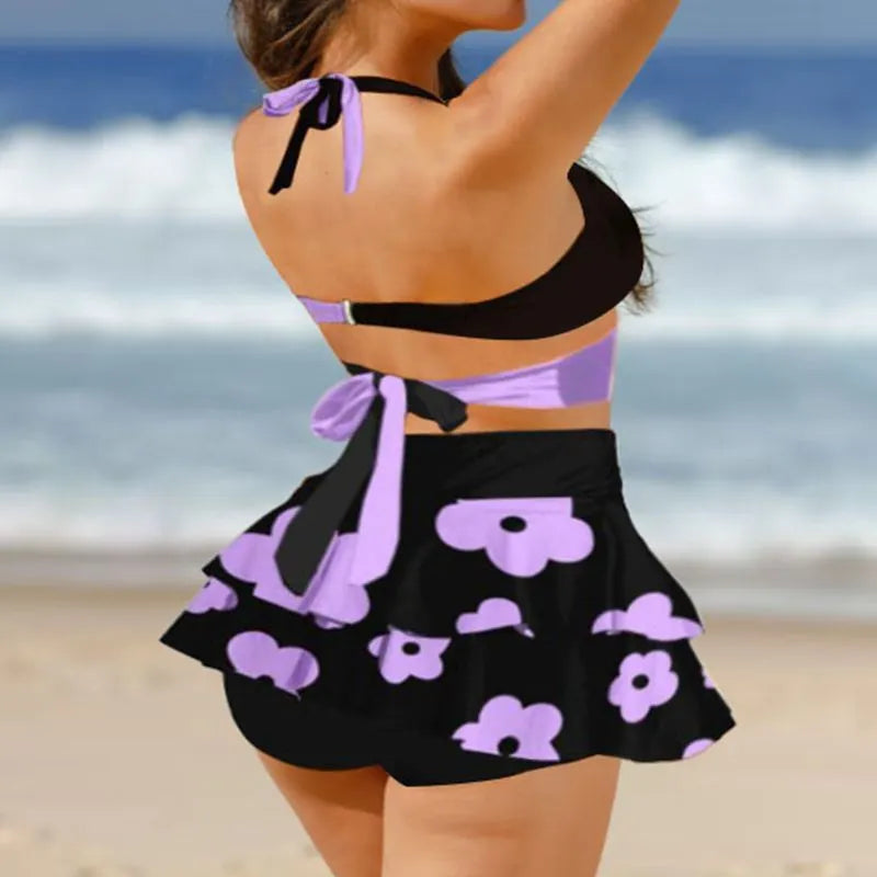 Purple high-waisted women's bikini swimsuit with lace-up detail and split skirt, showing backless design