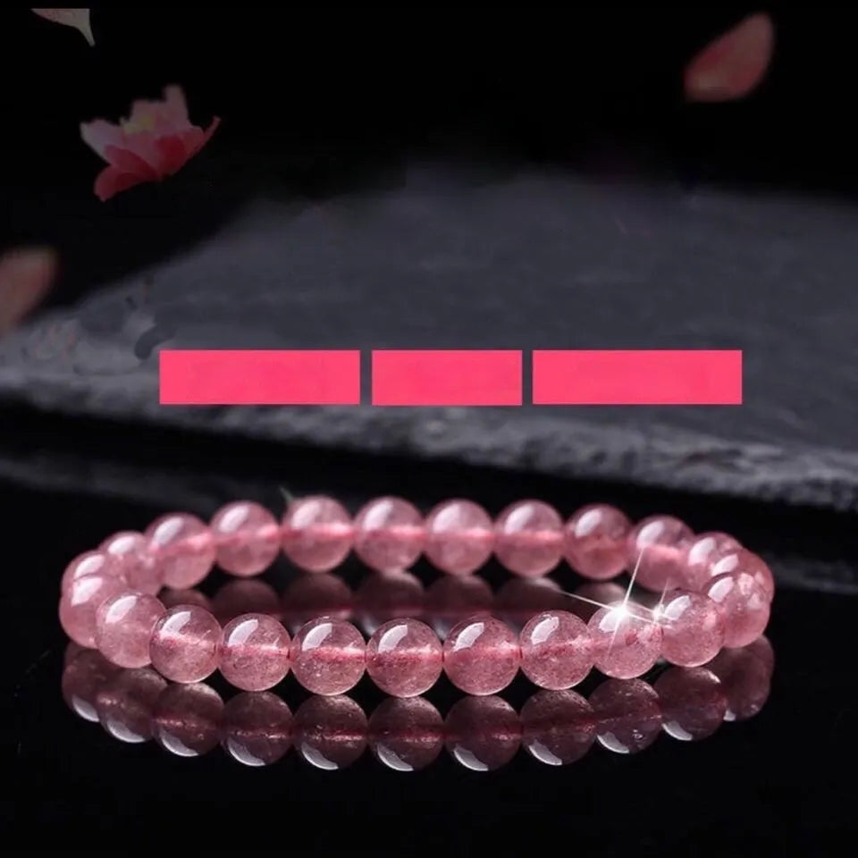 Women's strawberry quartz crystal bracelet with polished round beads.