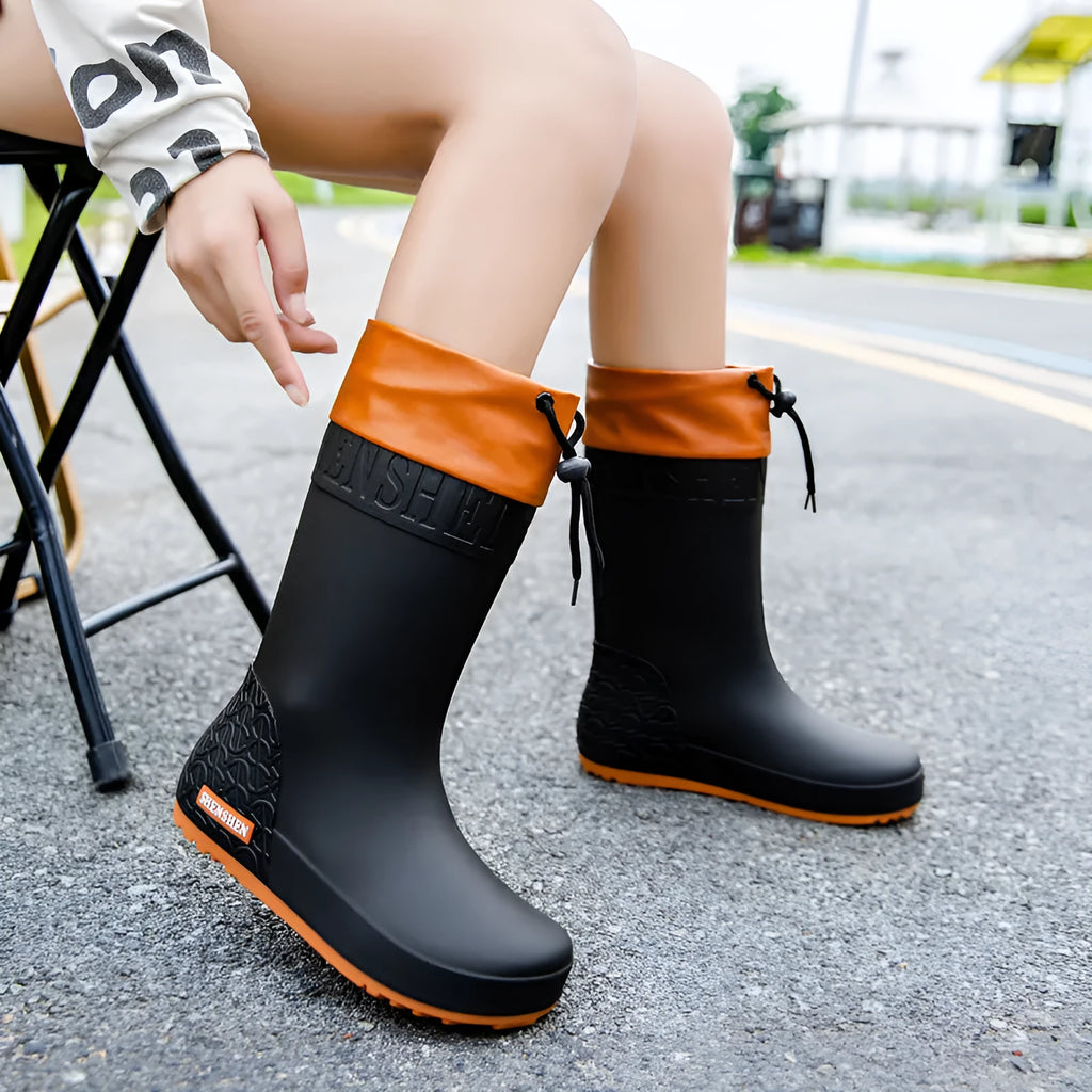 Women's solid colour PVC rain boots in apricot, shown with non-slip sole.