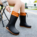 Women's solid colour PVC rain boots in apricot, shown with non-slip sole.