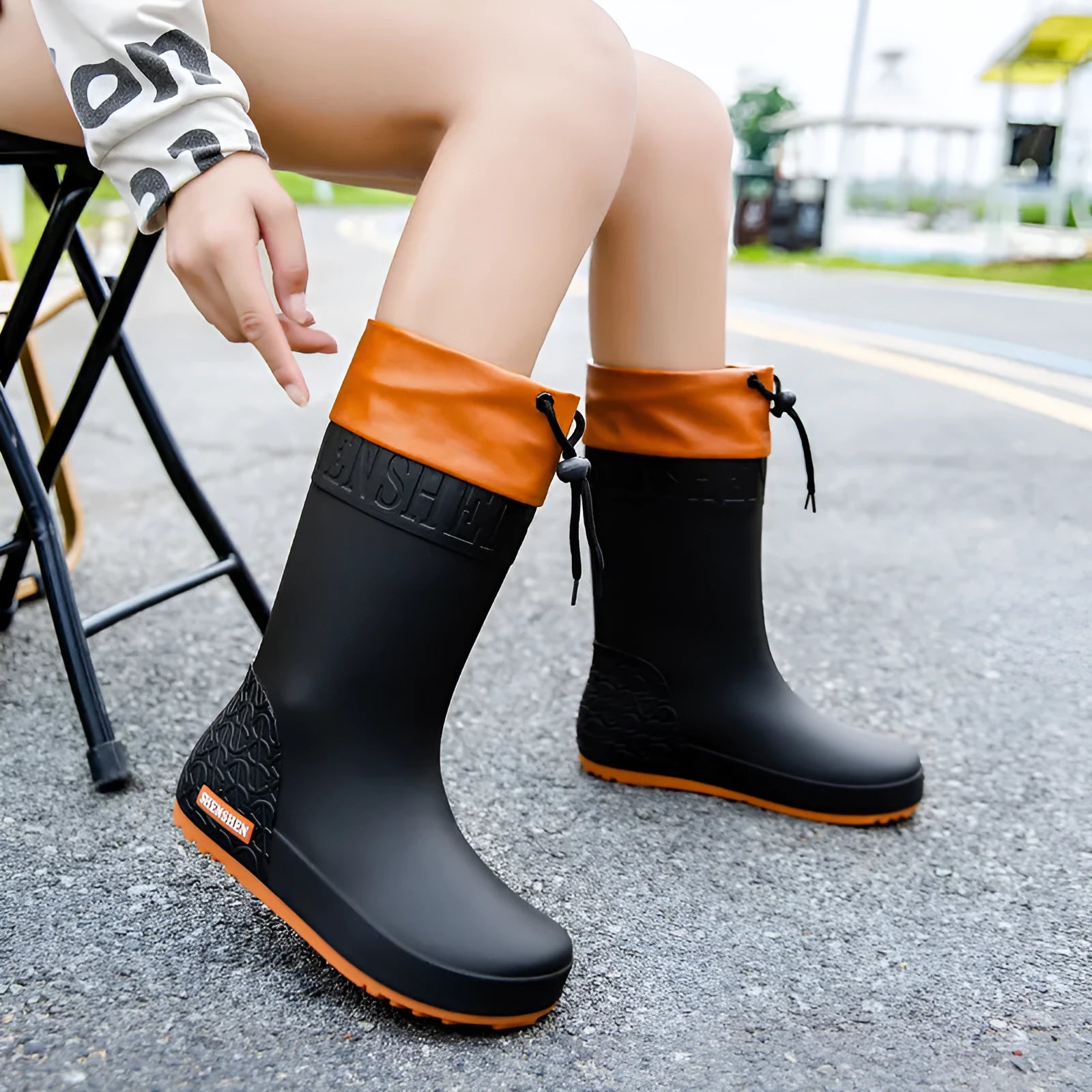 Women's solid colour PVC rain boots in apricot, shown with non-slip sole.