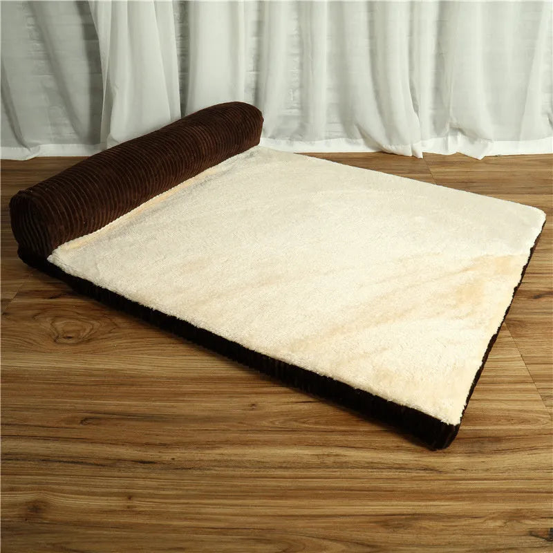 Corduroy dog sofa bed with bolster, shown in grey, placed on a wooden floor.