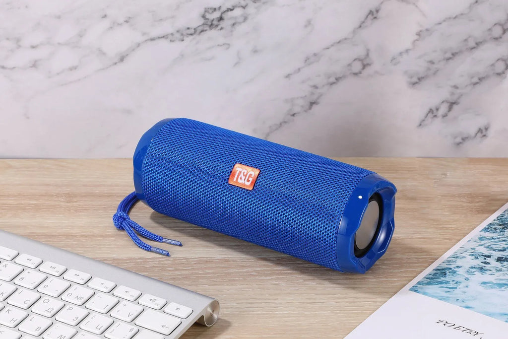 Fabric portable Bluetooth speaker with integrated card holder shown in multiple colour options.