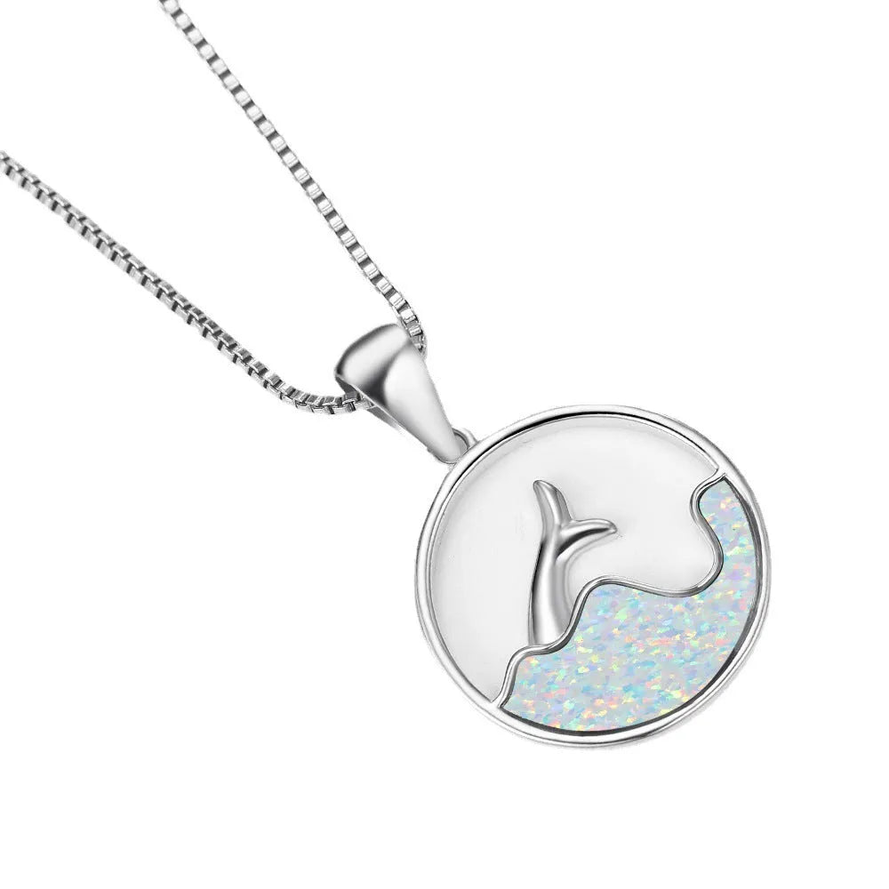 Geometric white gold fishtail necklace with round blue opal centre on model
