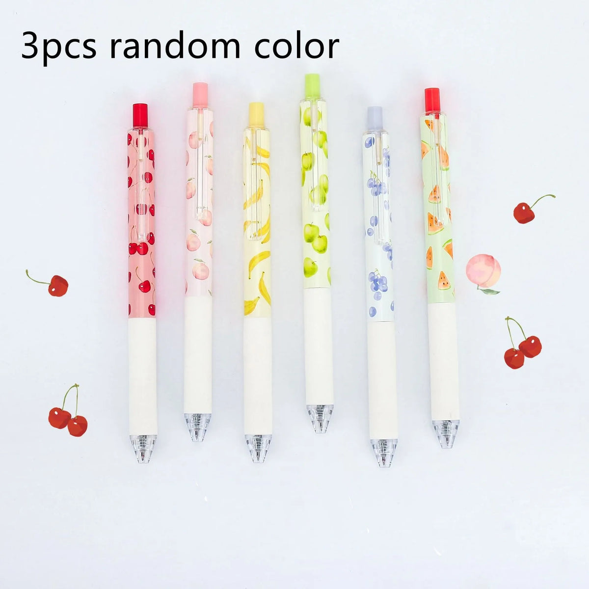 Three fruit-themed scented pressurised pens with 0.5mm black ink refills on writing surface