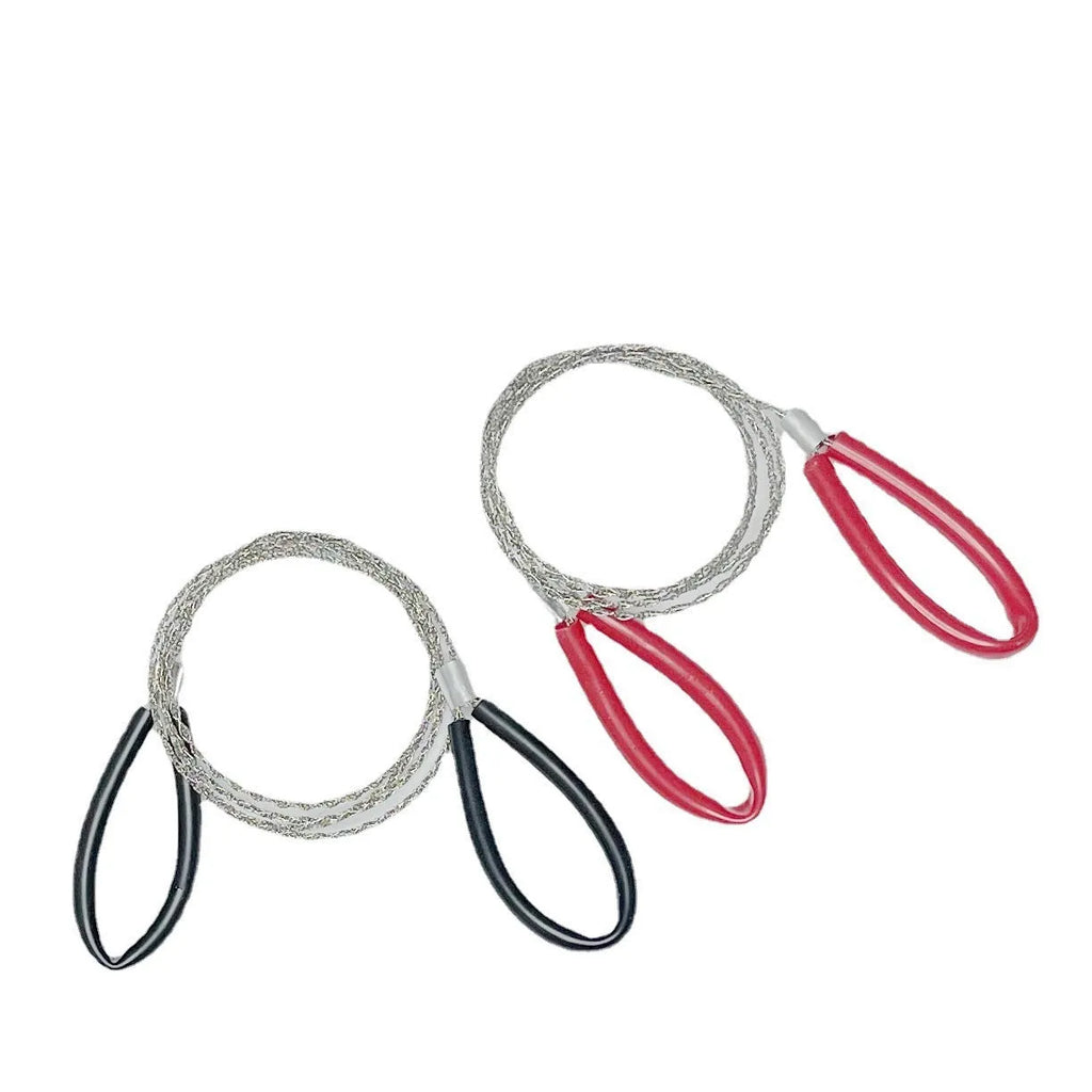 A coiled black or red survival wire saw made of braided stainless steel, shown with a scale indicating its small size.