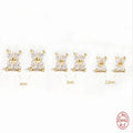S925 sterling silver stud earrings with crystal flowers in gold and platinum finishes on a grey background.
