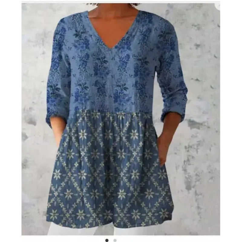 Women's loose-fit dress with a blue and white wave print, wide waist, and 3/4 length sleeves.