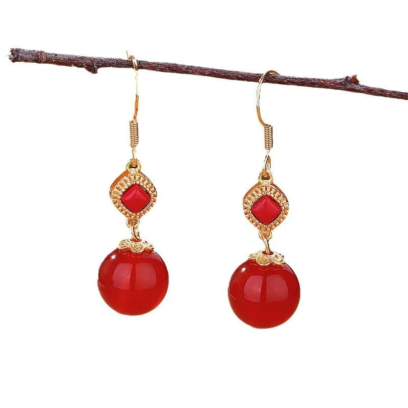 Geometric copper alloy earrings with a round Southern Red Agate bead and S925 sterling silver inlay details.