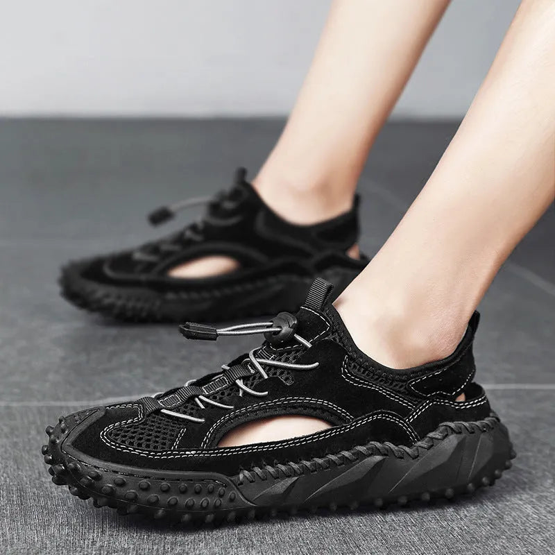 Men's black waterproof wading shoes with leather mesh upper, holes for drainage, and a rubber sole.