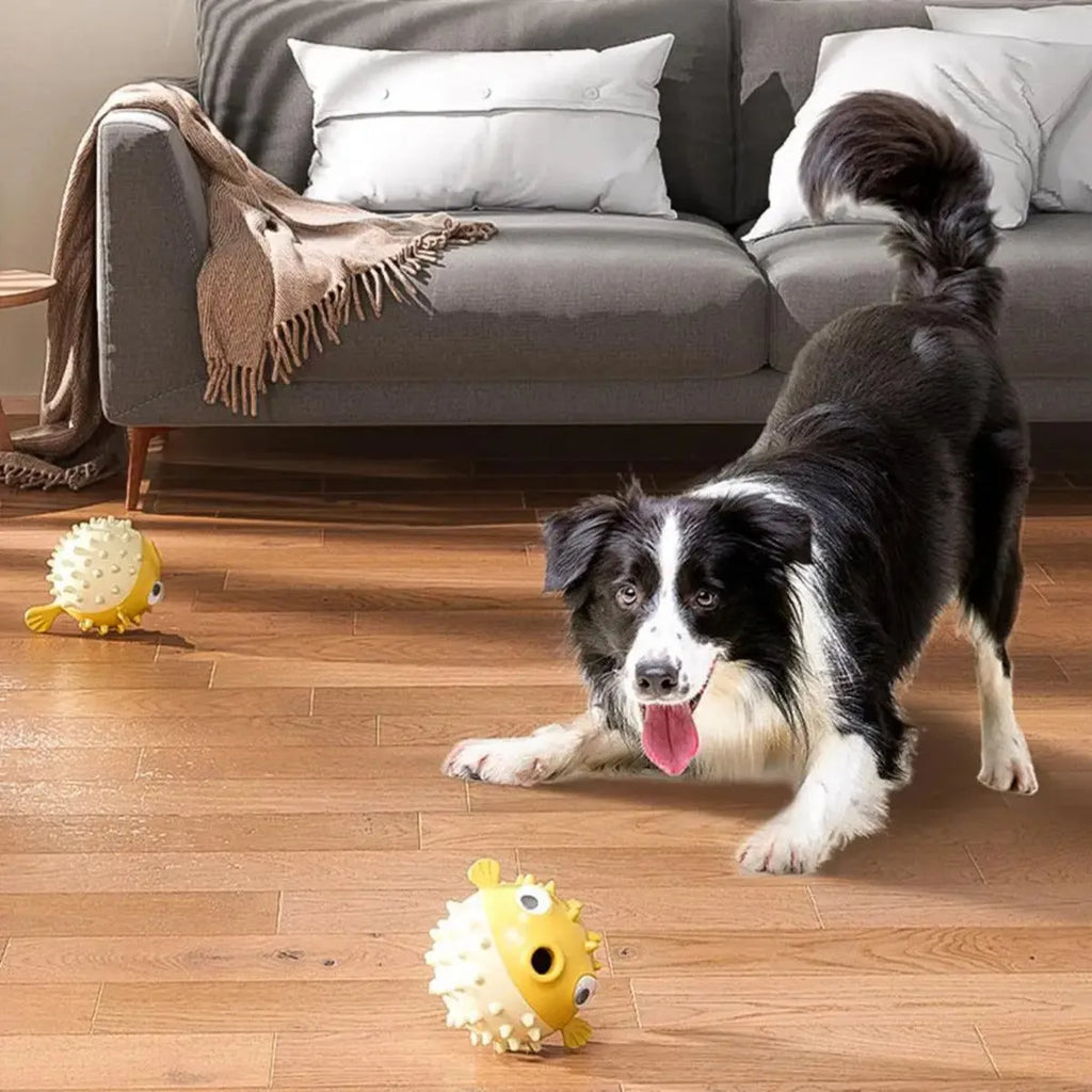 Yellow fish-shaped vinyl dog chew toy with textured surface and squeaker