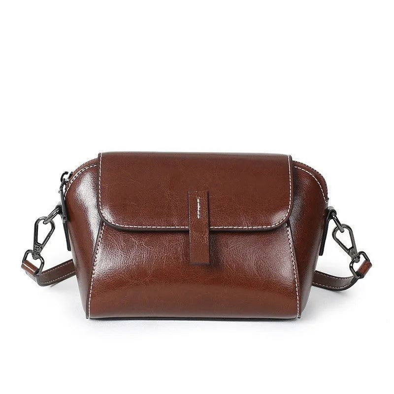 Women's brown oil wax cowhide leather shell shape messenger bag with cross-body strap and interior compartments