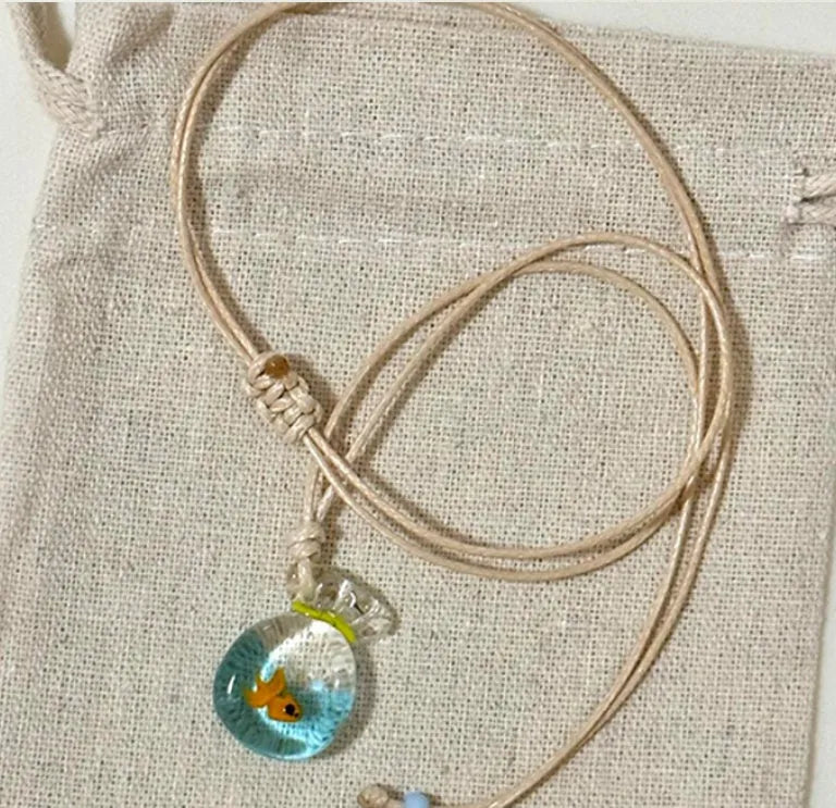 Women's joker design pendant necklace with coloured glaze charm on a cotton and linen clavicle chain.