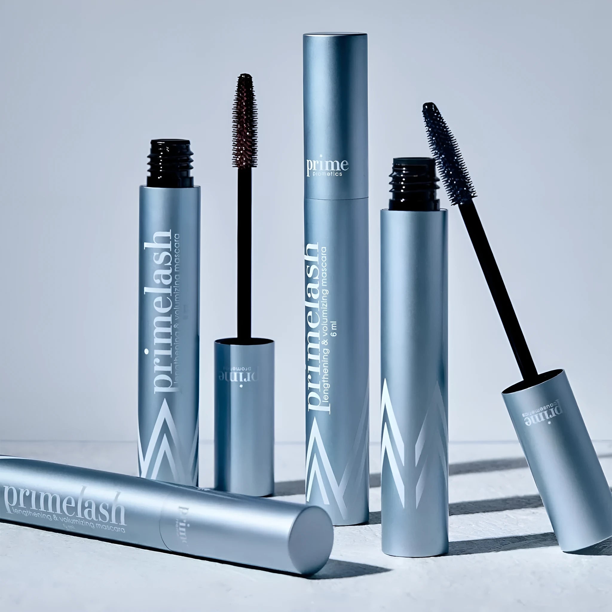 Eye black make-up tool with a small brush head and integrated comb for eyelash application and grooming.