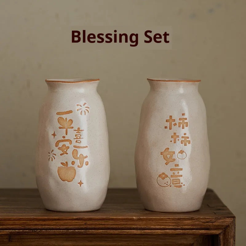 Chinese hand-painted ceramic vase with carved design on wooden desktop