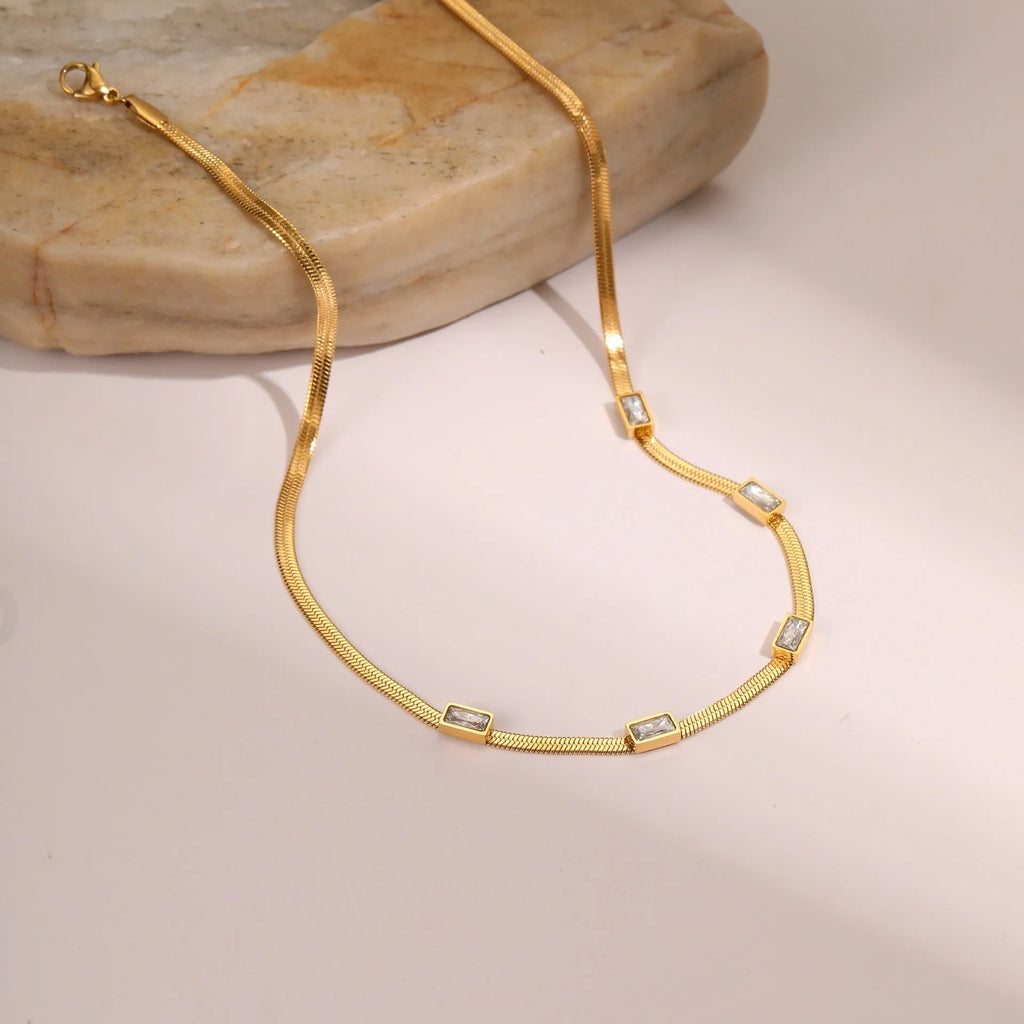 Geometric square zircon necklace in stainless steel with electroplated gold finish showing quadrilateral pattern
