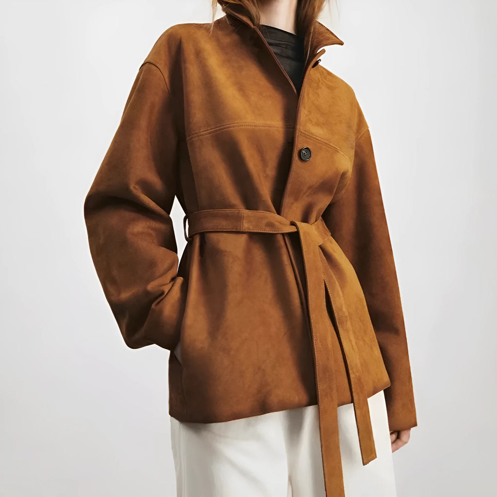 Women's caramel mocha cashmere coat with Peter Pan collar and belt, showing leather stitching and loose retro fit.