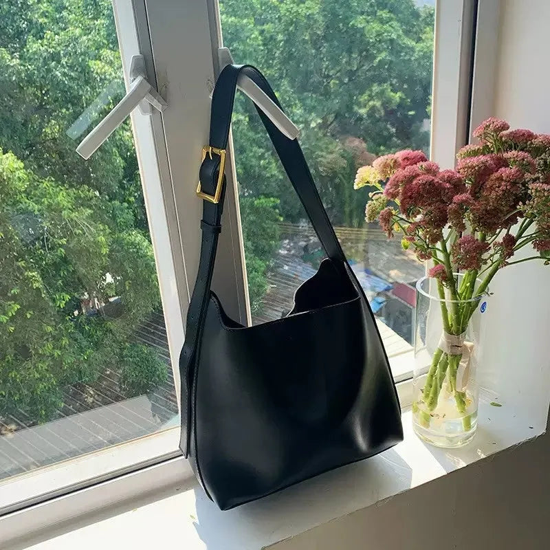 Women's soft PU leather shoulder bag with decorative swing threads in black or brown colour options