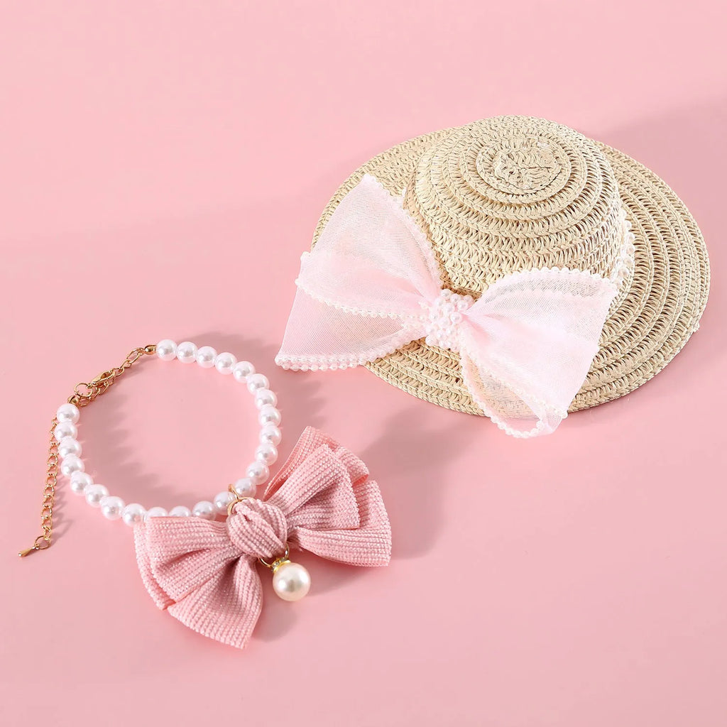 Cat wearing a woven Lafite leaves straw hat with a blue pearl butterfly bow.