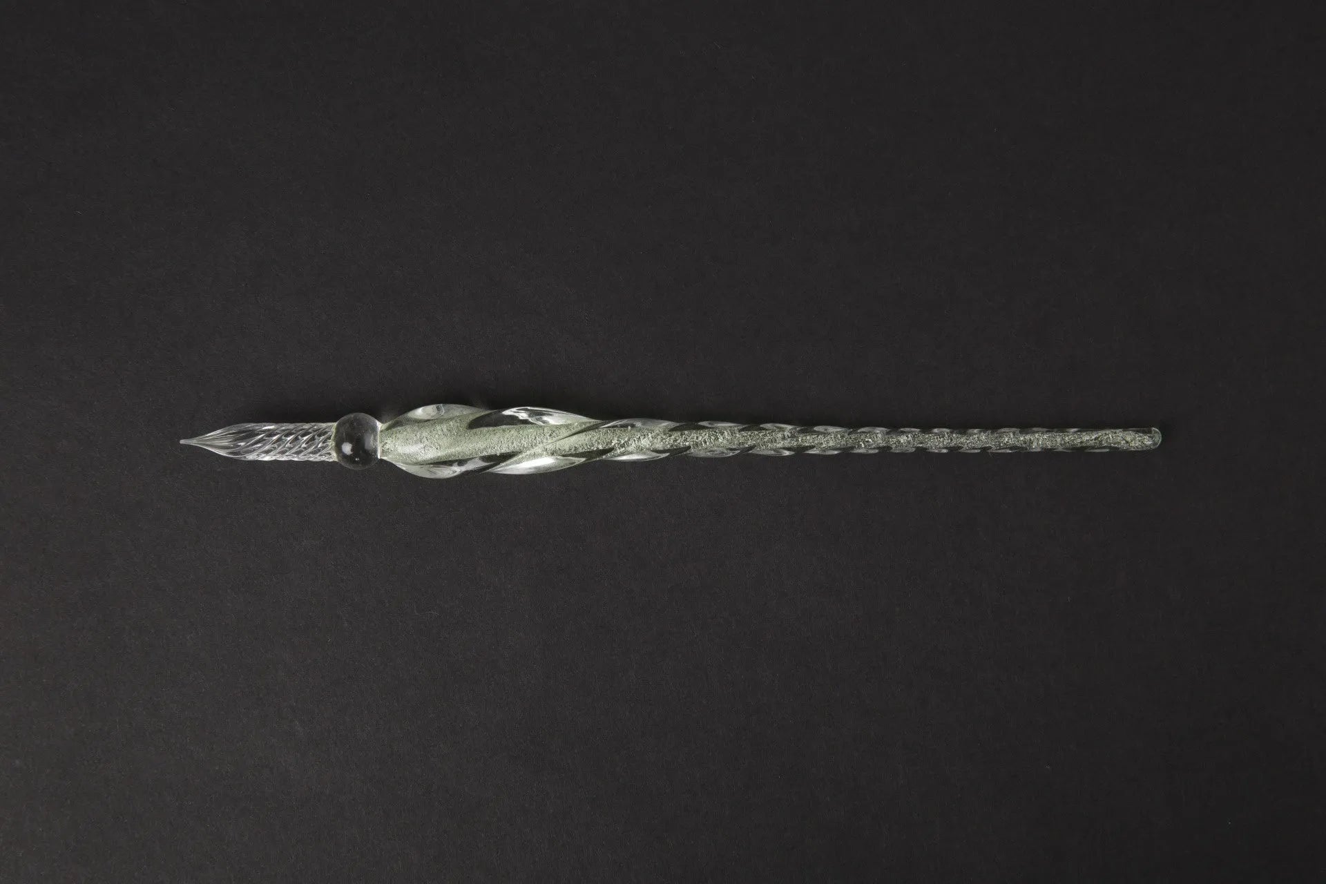 Transparent glass crystal pen with coloured ink visible inside, abstract modelling design