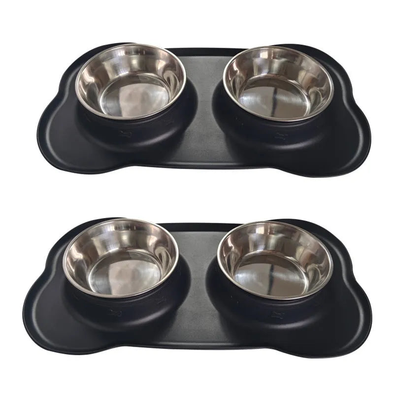 Large black silicone dog bowl sitting inside a stainless steel base, shown on a kitchen floor.