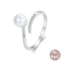 Adjustable sterling silver ring for women with a central shell pearl on an open-loop band.