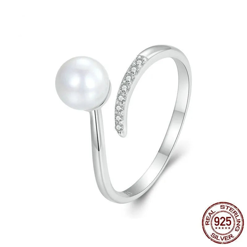 Adjustable sterling silver ring for women with a central shell pearl on an open-loop band.