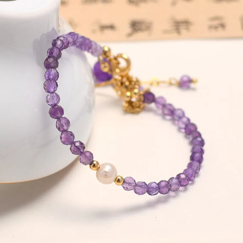 Chinese style women's crystal bracelet with amethyst coloured simulated diamond stones