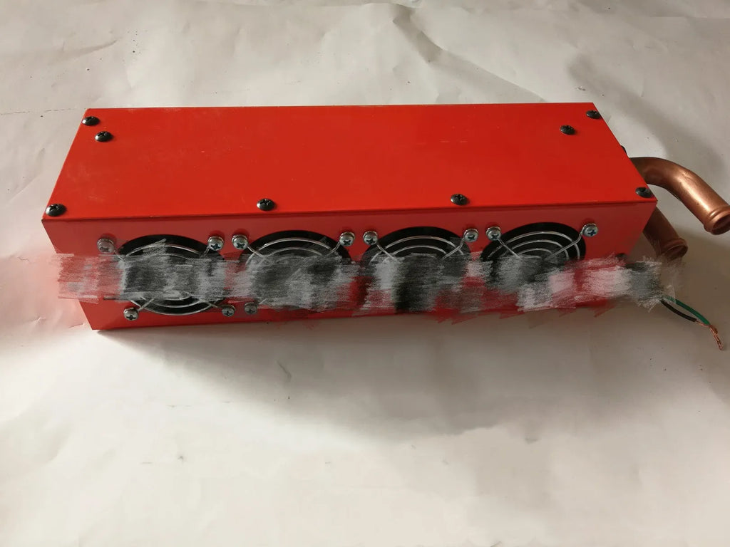 Small metal car heater core unit with copper pipes and electrical connections for 12V 24V installation.