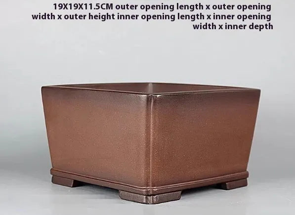 Brown handmade purple clay antique flower pot with single drainage hole.