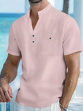 A man wearing a light-coloured linen blend stand collar t-shirt with short sleeves in a loose fit.