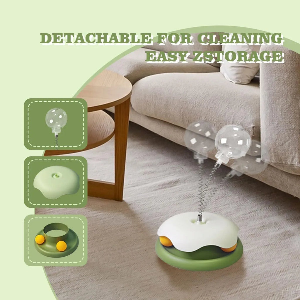 Blue and green interactive cat treat dispenser toy with track ball on flat surface